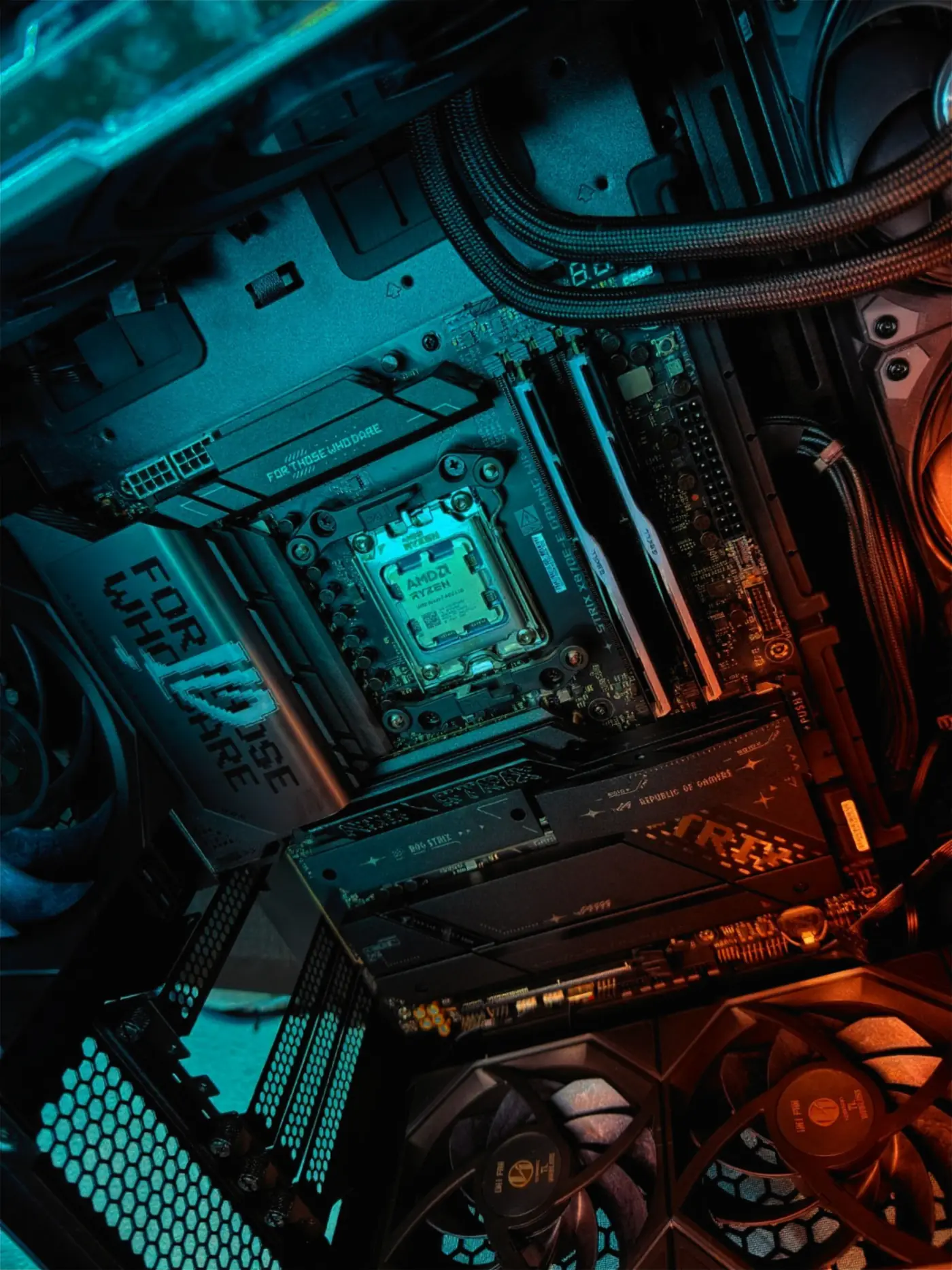 Inside an SCS build: an AMD Ryzen processor on an ASUS ROG Strix motherboard, lit in teal and amber